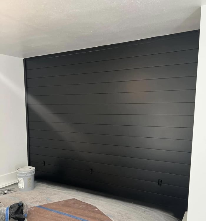 A black wall with paneling