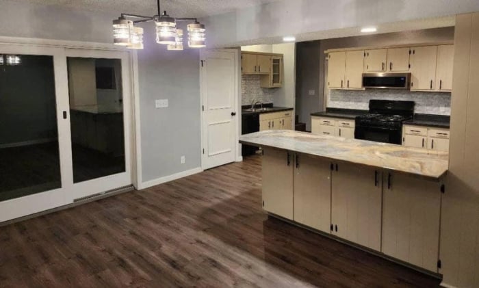 A finished kitchen with a epoxy table